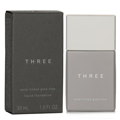 THREE Solar getönte Glow Flow Flüssiggrundierung LSF 50 – Nr. 01, 30 ml