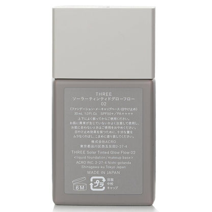 THREE Solar getönte Glow Flow Flüssiggrundierung LSF 50 – Nr. 02, 30 ml